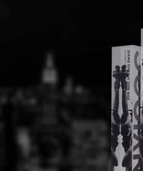 Three award bottles from the 2016 New York International Olive Oil Competition displayed against a blurred city background. - Olive Oil Times