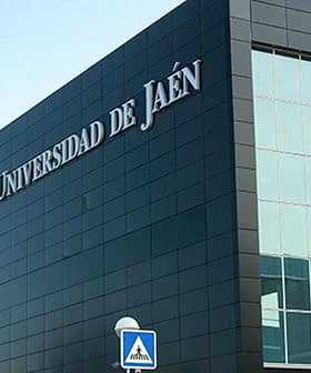 Modern architecture of the Universidad de Jaén with large glass windows and a black exterior. - Olive Oil Times
