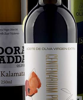 A collection of olive oil bottles featuring different brands and labels on a neutral background. - Olive Oil Times