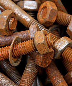 A collection of rusty bolts and nuts piled together in a disorganized manner. - Olive Oil Times