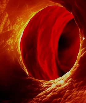 Abstract view of a circular tunnel illuminated with red and orange hues. - Olive Oil Times
