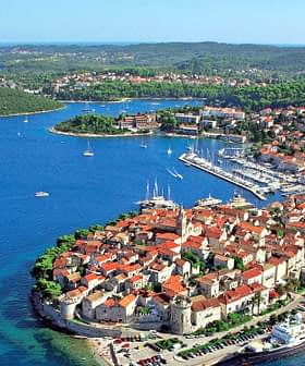 Aerial view of Korčula Island featuring the town and surrounding sea with boats. - Olive Oil Times