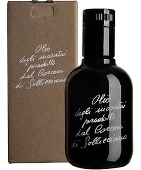 Black glass bottle of olive oil with a cardboard box featuring handwritten text. - Olive Oil Times