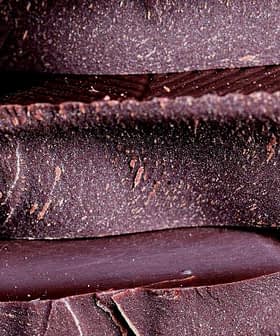 Close-up view of stacked layers of dark chocolate with a textured surface. - Olive Oil Times