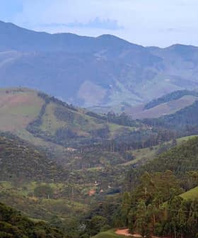 Expansive view of a mountainous landscape featuring rolling green hills and distant peaks. - Olive Oil Times