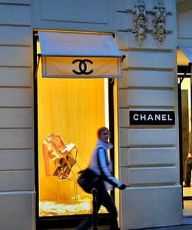 Chanel storefront featuring display windows with mannequins and branding. - Olive Oil Times
