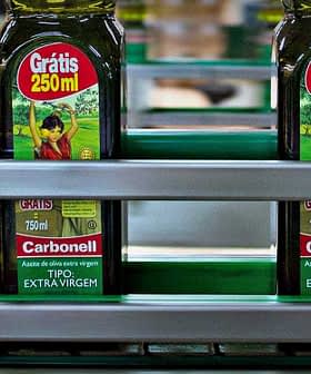 Bottles of Carbonell extra virgin olive oil labeled 250ml on a production line. - Olive Oil Times
