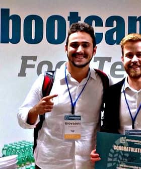 Three individuals posing together at a Startup Bootcamp Food Tech event with a sign in the background. - Olive Oil Times