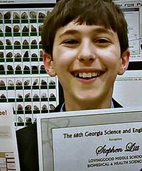 Young student holding a certificate and ribbon at a science and engineering fair. - Olive Oil Times