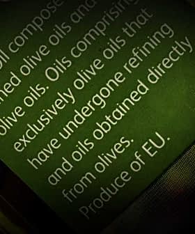 Close-up of an olive oil label detailing composition and origin of the oil. - Olive Oil Times