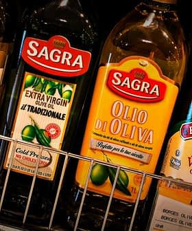 Various bottles of olive oil displayed on a shelf, including brands like Sagras and Borges. - Olive Oil Times