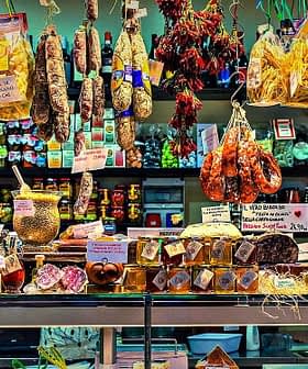 A market display featuring various food products including pasta, meats, and preserves. - Olive Oil Times