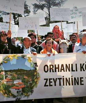 Group of protesters holding banners and signs during a demonstration in Orhanlı Village against a quarry operation. - Olive Oil Times