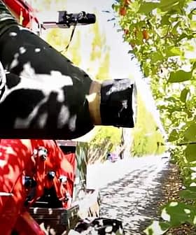 Close-up of a fruit harvesting machine positioned near apple trees in an orchard. - Olive Oil Times