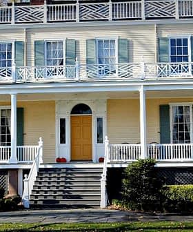 Two-story historic house featuring a large front porch and multiple windows. - Olive Oil Times