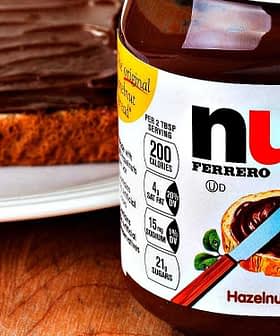 Jar of Nutella hazelnut spread next to a slice of bread topped with the spread. - Olive Oil Times