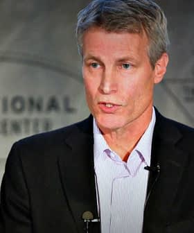 A man delivering a presentation at the International Culinary Center with a microphone attached. - Olive Oil Times