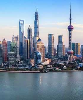 Panoramic view of the Shanghai skyline featuring modern skyscrapers and the Huangpu River. - Olive Oil Times