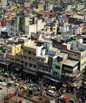 Aerial view of a densely populated urban area with various buildings and streets visible. - Olive Oil Times