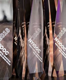 Collection of awards with the year 2018 displayed on a shelf against a brick wall. - Olive Oil Times