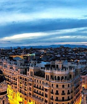 Panoramic view of Madrid's skyline featuring buildings and a twilight sky. - Olive Oil Times