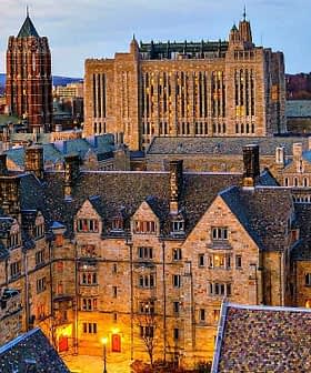 Aerial view of Yale University campus showcasing historic buildings and architecture at dusk. - Olive Oil Times