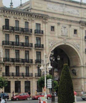 Facade of the Banco Santander building featuring ornate architectural details and balconies. - Olive Oil Times