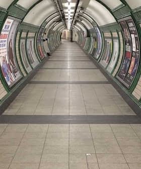 Interior view of a London Underground tunnel featuring artwork on the walls and signage for the Bakerloo Line. - Olive Oil Times