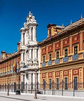 Historical building in Seville featuring an ornate facade and decorative elements. - Olive Oil Times