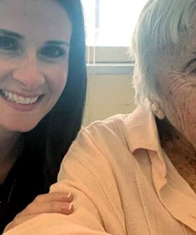 A woman with long dark hair smiling next to an elderly lady with gray hair wearing a light pink blouse. - Olive Oil Times