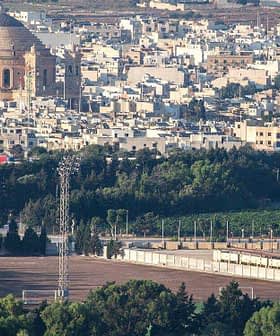Aerial view of a city featuring a large dome structure and surrounding buildings. - Olive Oil Times