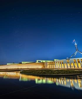 Night view of Parliament House in Canberra with reflections in the water. - Olive Oil Times