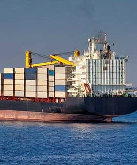 Large container ship with stacked cargo containers sailing in open water. - Olive Oil Times