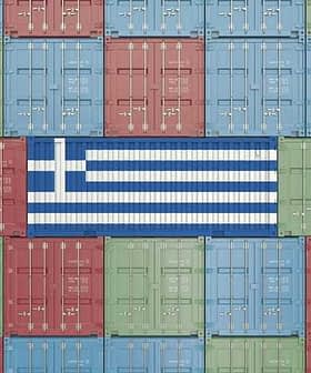 Shipping containers arranged in a pattern with the Greek flag in the center. - Olive Oil Times