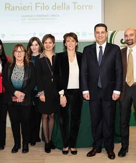 Group of individuals posing together at the Ranieri Filo della Torre event in Italy. - Olive Oil Times