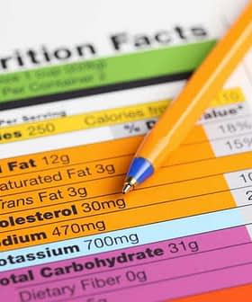Nutrition facts label with details on calories, fat, sodium, and carbohydrates next to a blue pen. - Olive Oil Times