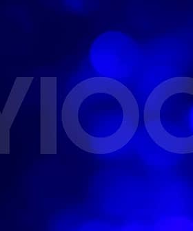 Abstract blue background featuring the text 'NYIOOC' in large letters. - Olive Oil Times