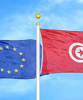 Flags of the European Union and Tunisia waving against a blue sky. - Olive Oil Times