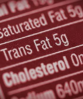 Close-up of a nutrition label indicating 5g of trans fat content. - Olive Oil Times