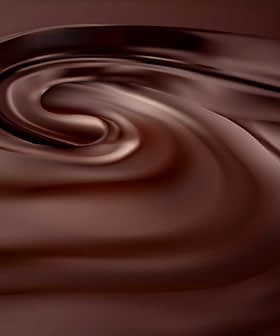 Smooth, swirling texture of dark chocolate with a glossy finish. - Olive Oil Times