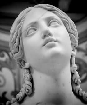 Close-up of a marble sculpture depicting a female figure with long hair and a serene expression. - Olive Oil Times