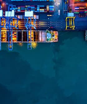 Aerial view of a container port with cranes and cargo containers at night. - Olive Oil Times