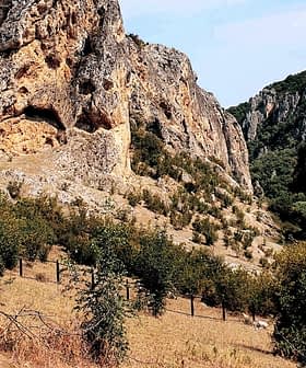 Rocky terrain featuring steep cliffs and scattered trees in a natural setting. - Olive Oil Times