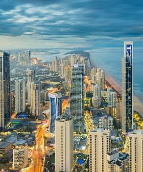 Aerial view of Gold Coast city skyline with high-rise buildings and coastline at dusk. - Olive Oil Times