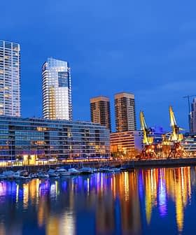 Night view of Buenos Aires cityscape with skyscrapers and waterfront reflections. - Olive Oil Times