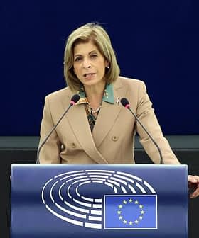 A woman speaking at a podium with the European Parliament logo during a session. - Olive Oil Times