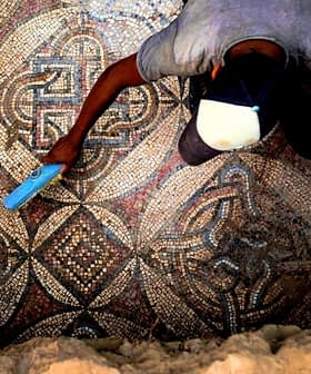 An archaeologist using a tool to clean an intricate ancient mosaic floor. - Olive Oil Times