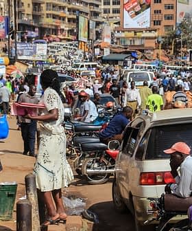 Crowded street in Kampala with pedestrians and vehicles, showcasing daily urban life. - Olive Oil Times