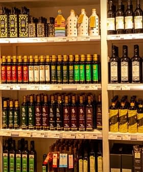 Shelves displaying a variety of olive oil bottles in different shapes and sizes. - Olive Oil Times