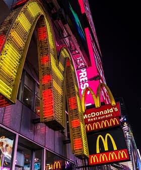 Illuminated McDonald's restaurant signage featuring the iconic golden arches at night. - Olive Oil Times